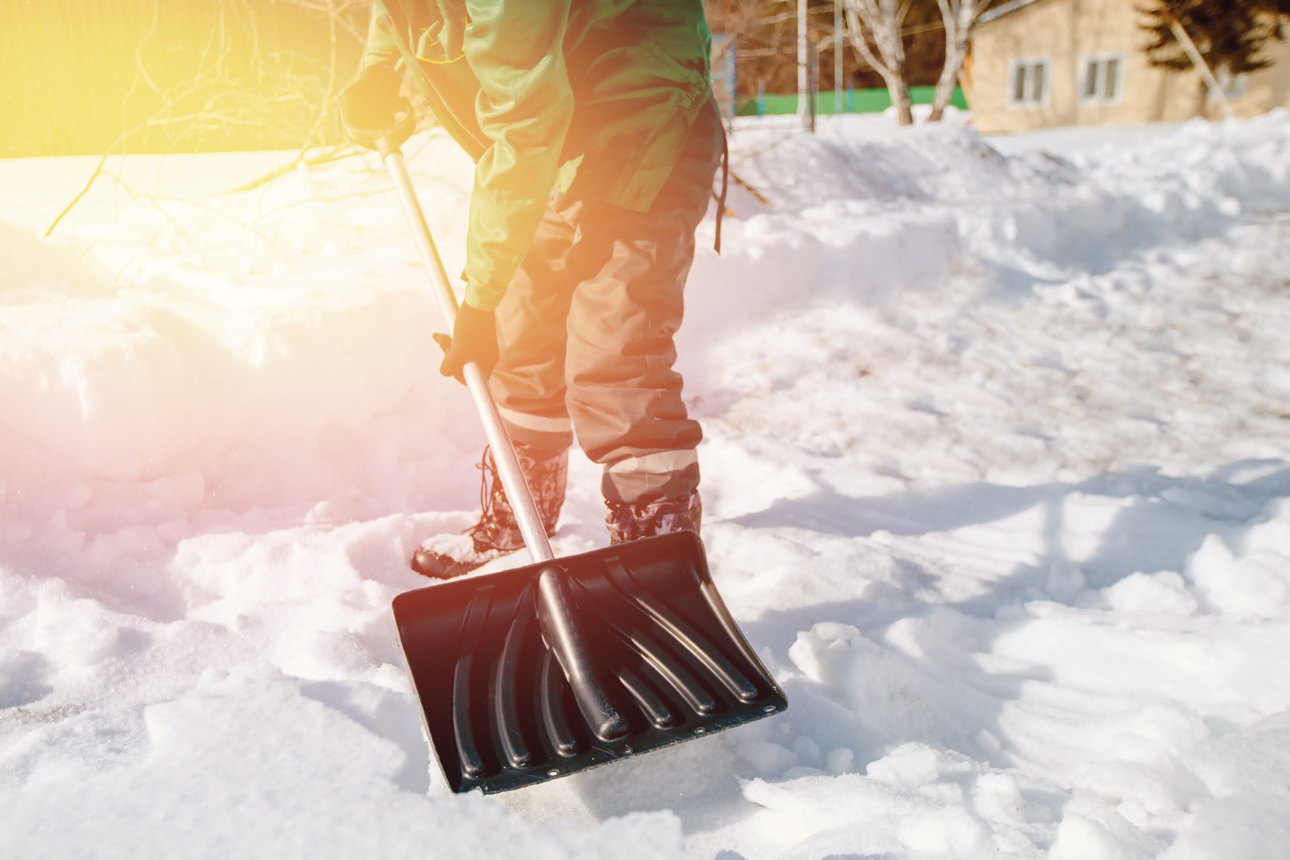 A person using a shovel to remove snow.