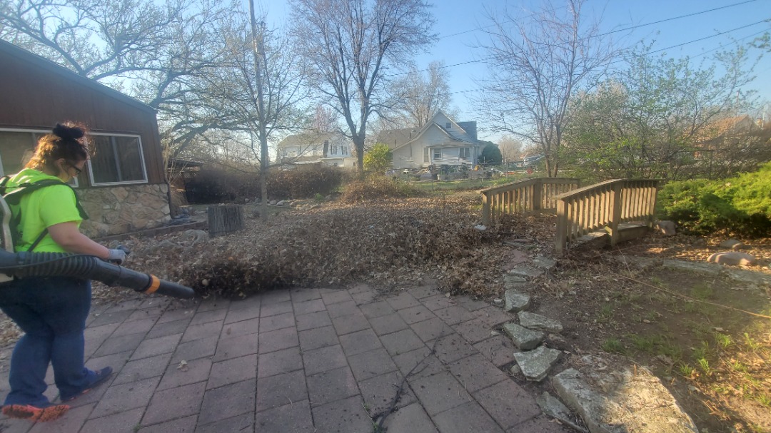 A Divine Lawn’s worker taking care of a yard clean up job.